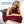 Woman lying on a bed using a Venture Heat infrared heating pad