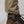 FjallRaven trouser hem with adjustable drawstring cord lock above brown hiking boot