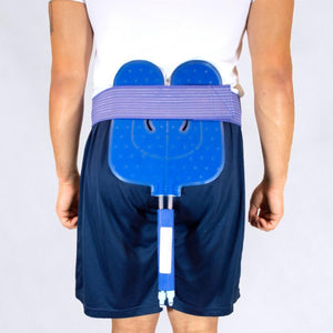 Person wearing a blue gel cold therapy wrap secured around the lower back with a purple elastic strap