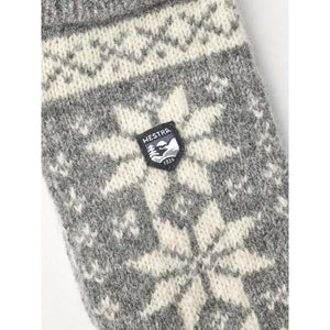 Hestra grey and white wool knit mitten with snowflake pattern and brand logo patch
