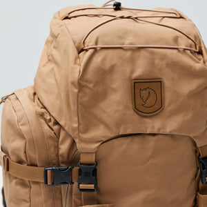 Tan FjallRaven backpack with top lid and elastic cord detail