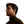 Profile view of a man wearing black open ear wireless earbuds