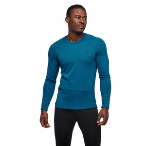 Man wearing a blue Black Diamond long sleeve crew neck base layer