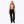 Woman wearing black ski pants with suspenders and black ski boots