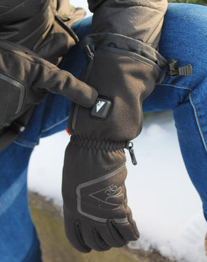 Person wearing black heated gloves with a power button on the wrist