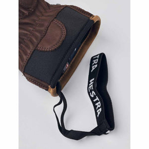Brown leather Hestra glove cuff with elastic wrist strap