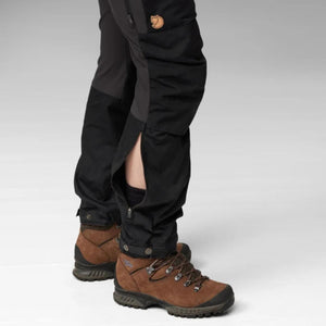 Fjallraven trekking trousers with side ventilation zippers open at the calf worn with brown hiking boots