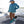 Woman wearing a blue Huk hoodie and blue boots standing on a boat deck