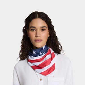 Woman wearing a Mission neck gaiter with an American flag print