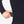 Hand placing a Venture Heat battery pack into a zippered pocket on a black long sleeve shirt