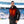 Man wearing a black heated puffer jacket with visible red heating elements on the chest