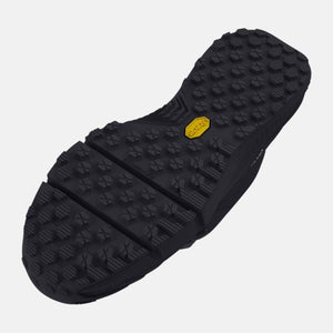 Under Armour shoe outsole with black lugged tread pattern and yellow Vibram logo