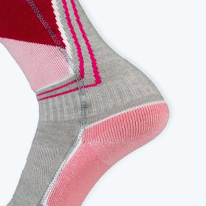 Close up of a grey pink and red athletic sock with ribbed texture and zigzag stitching