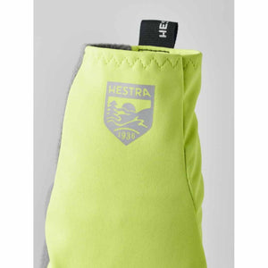 Neon yellow Hestra glove cuff with brand logo and pull tab