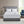 White heated mattress pad on a bed with two pillows and dual controllers