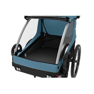 Blue Thule bike trailer with empty interior and transparent side windows