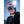 Person wearing a Smith Optics pink ski helmet and mirrored goggles against a bright blue sky