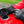 Warm and Safe black leather motorcycle gloves on a red fuel tank