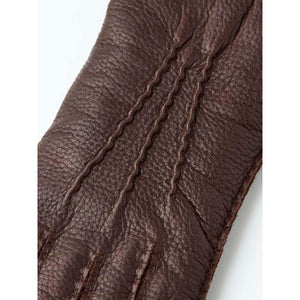 Brown Hestra leather glove with three decorative stitched lines on the back