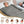 Woman lying in a grey infrared sauna blanket with icons showing health benefits
