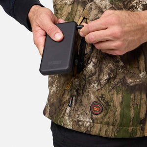 Person connecting a Mobile Warming power bank to a camo vest