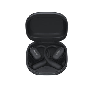 Black Shokz OpenFit earbuds inside an open charging case