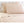 Shavel tan solid color bed sheet set with two pillows against a tufted headboard