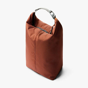 Bellroy rust colored grid pattern roll top bag with grey handle