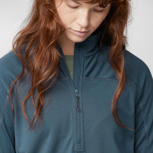 Person wearing a dark blue FjallRaven half zip fleece top