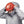 Person wearing a Black Diamond jacket and red climbing helmet pulling the hood over the helmet