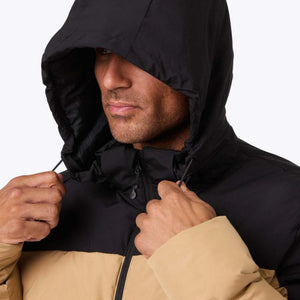 Man wearing a black and tan Mobile Warming hooded jacket with drawstring pulled