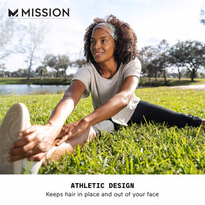 Woman wearing a Mission patterned headband while stretching on grass