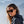 Woman wearing Smith Optics sunglasses with dark frames and brown lenses