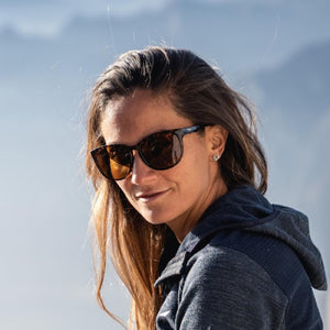 Woman wearing Smith Optics sunglasses with dark frames and brown lenses