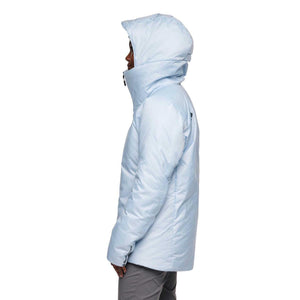 Side view of a person wearing a light blue Black Diamond insulated hooded jacket