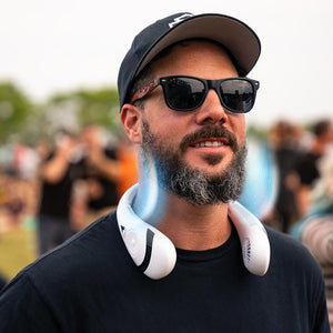 Man wearing a white AlphaCool portable neck fan with blue air flow visual effects
