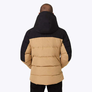 Back view of a person wearing a tan and black Mobile Warming hooded puffer jacket