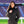 Woman wearing a black ActionHeat heated jacket with a faux fur hood at a stadium