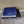 Mattress Cooler unit with a blue grid patterned cooling pad folded on top