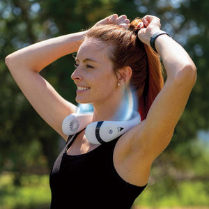 Woman wearing a white Alphacool portable neck fan outdoors