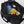 Open black Got Bag duffel containing a towel, banana, apple, umbrella, and charger