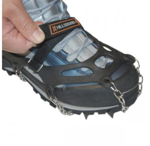 Hand tightening a Hillsound traction device strap over a hiking boot