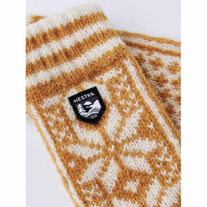 Hestra knit fabric with yellow and white fair isle pattern and Hestra brand patch