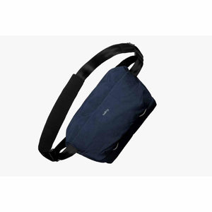 Navy blue Bellroy sling bag with black adjustable strap