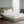 Serta white mattress pad on a bed with a tufted headboard
