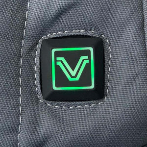 Green illuminated power button with V logo on grey fabric