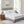 White quilted mattress protector on a bed with two pillows and wooden nightstands