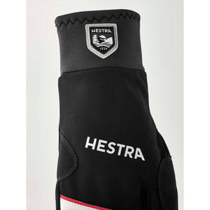 Hestra black glove with brand logo patch and white text