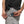 Person wearing an AlphaCool personal cooling device clipped to their waistband with a handheld controller