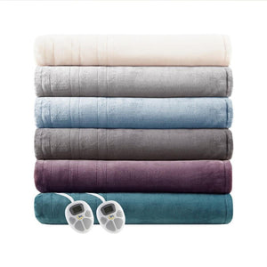 Stack of six folded Serta electric blankets in various colors with two digital controllers